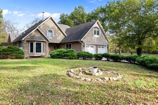 Stone home with landscaping